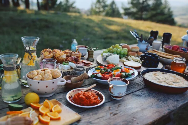 A rustic wooden table set with lunch